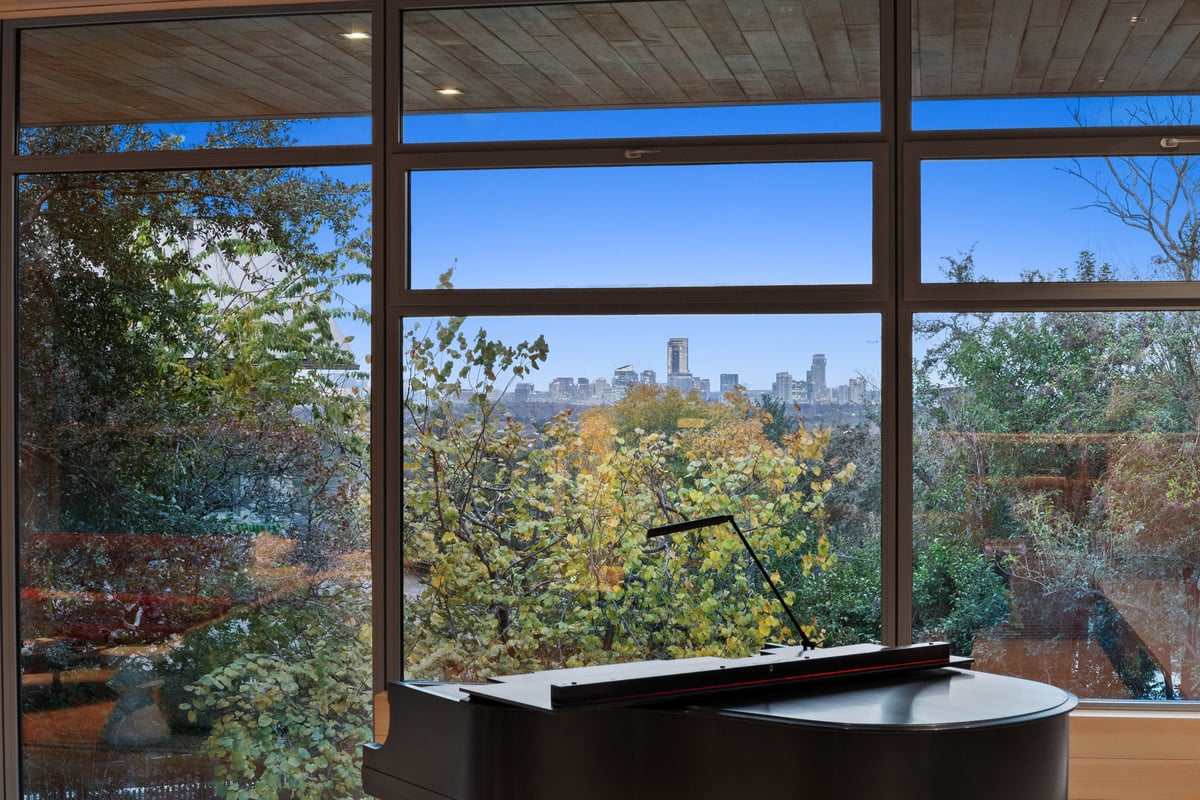 Window seat framing the downtown Austin skyline above the treetops