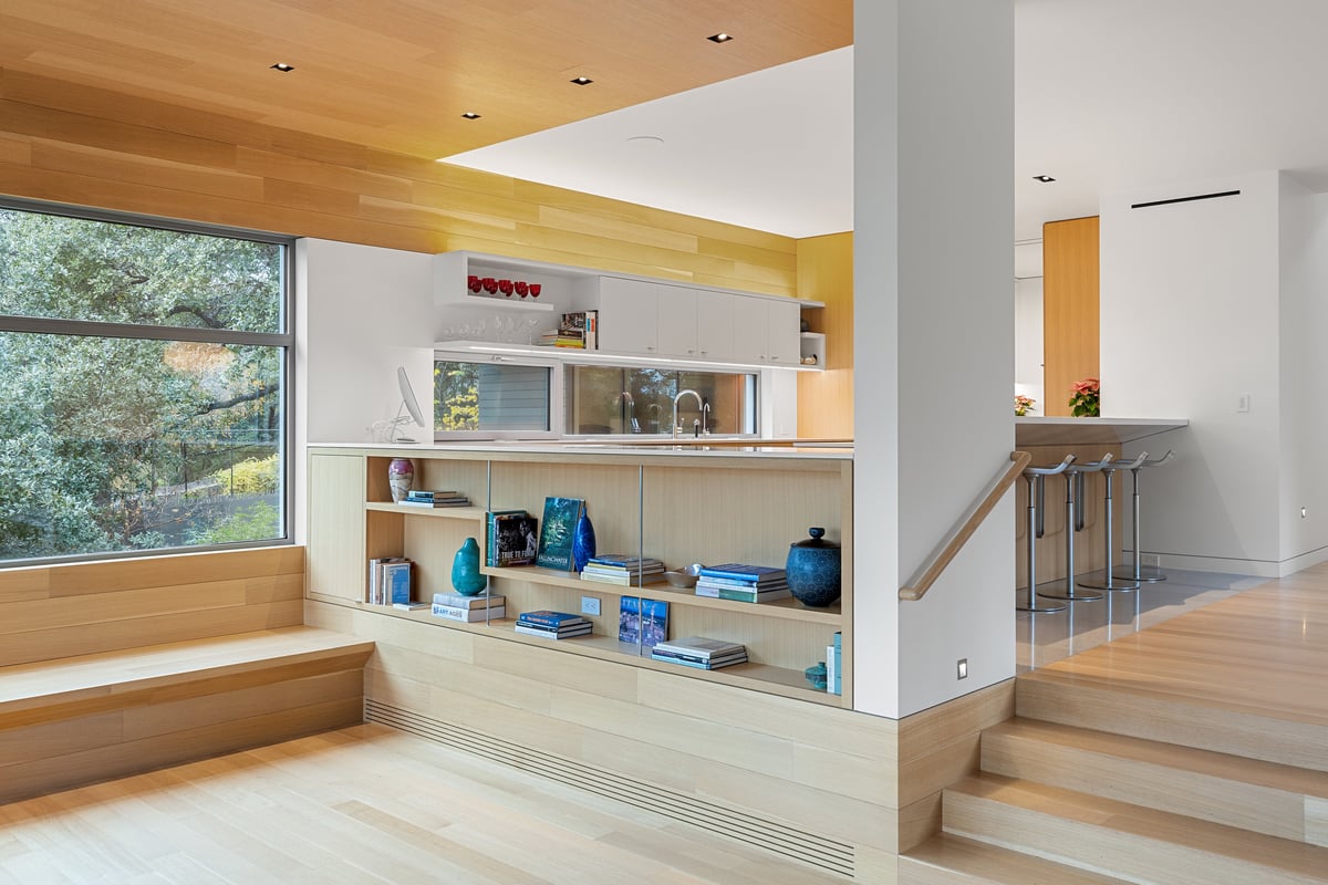 Built-in window bench and shelving along the great room glass