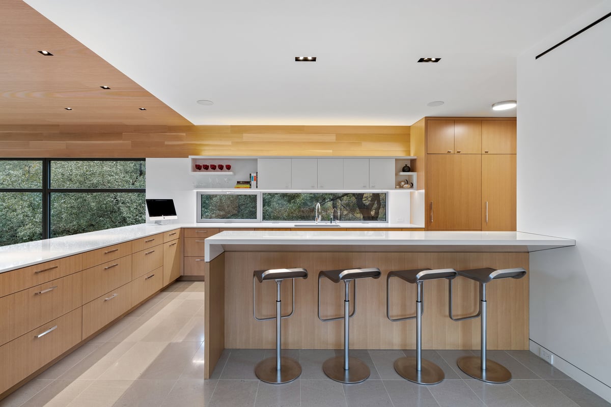 Kitchen island with bar seating and clerestory windows over the counter