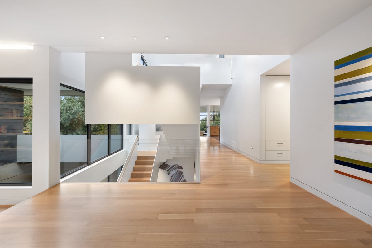 Upper hallway with gallery walls and a view down to the stair
