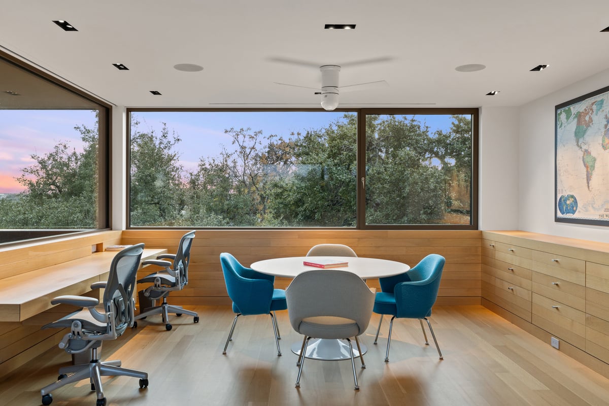 Upstairs study with built-in desks and windows on two sides