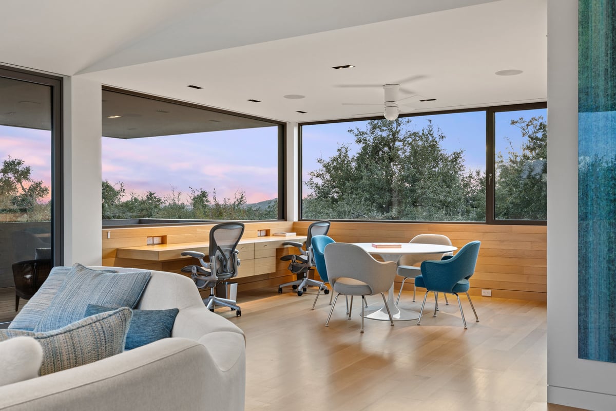 Upstairs family room and work area with a long view over the trees
