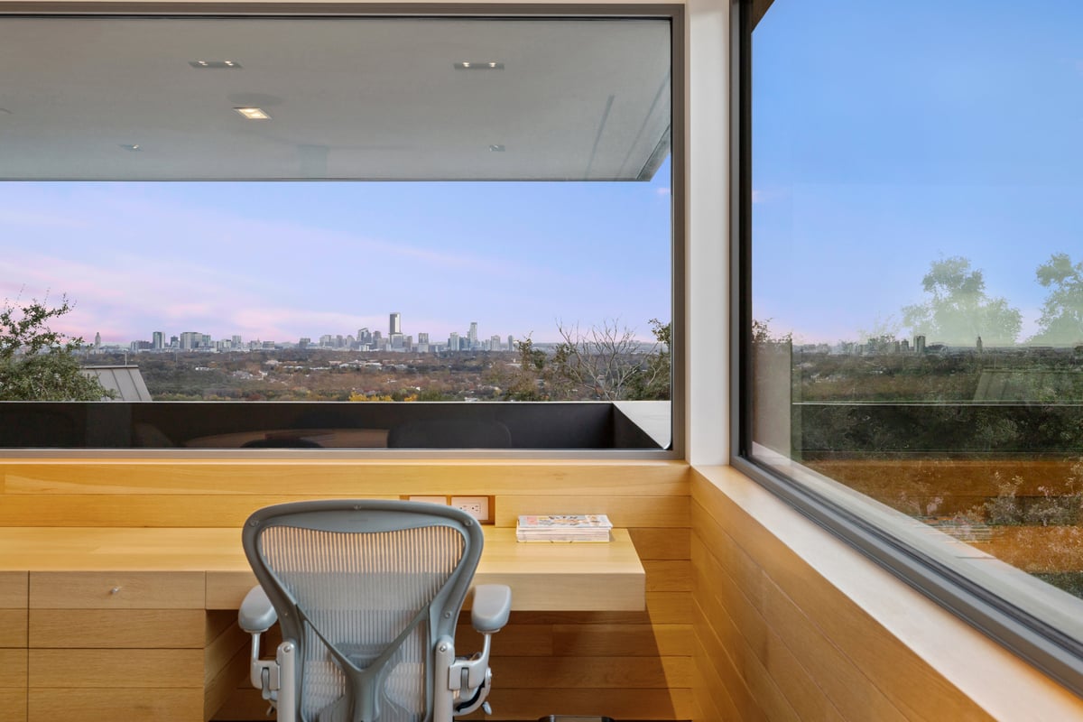 Corner desk with a task chair looking out to the downtown skyline