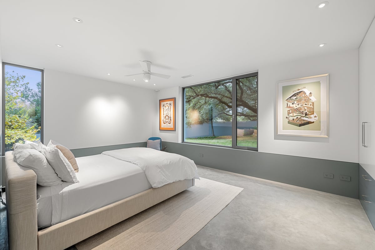 Guest bedroom with a window to the lawn and framed art