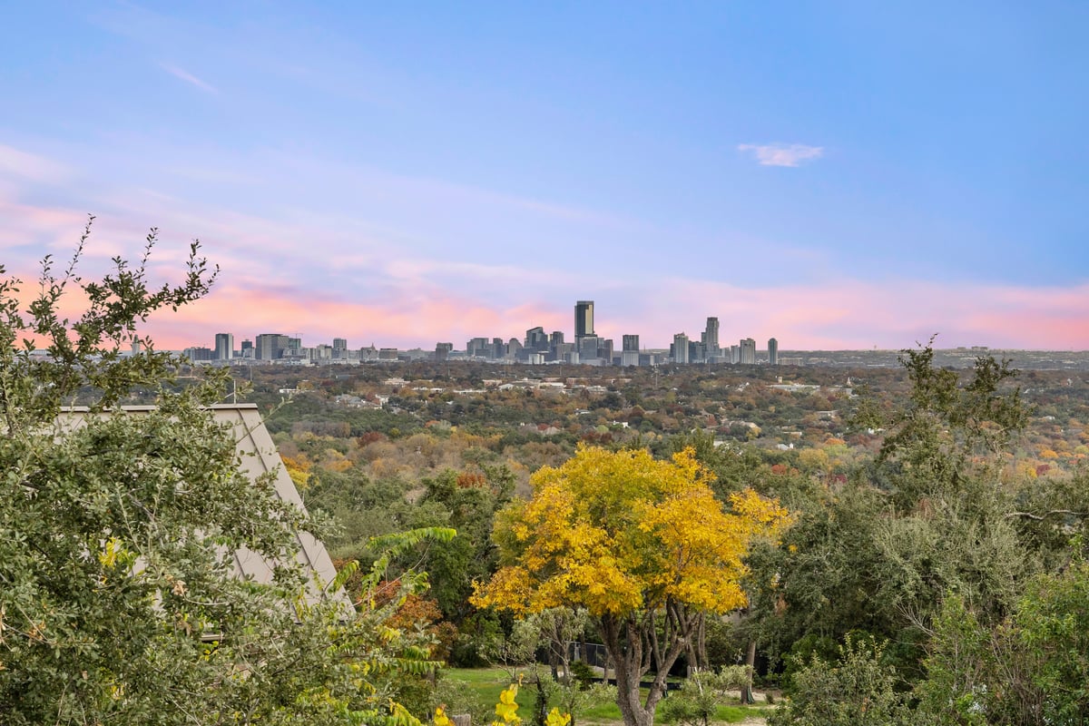 Downtown Austin skyline at dusk over the hills west of the city
