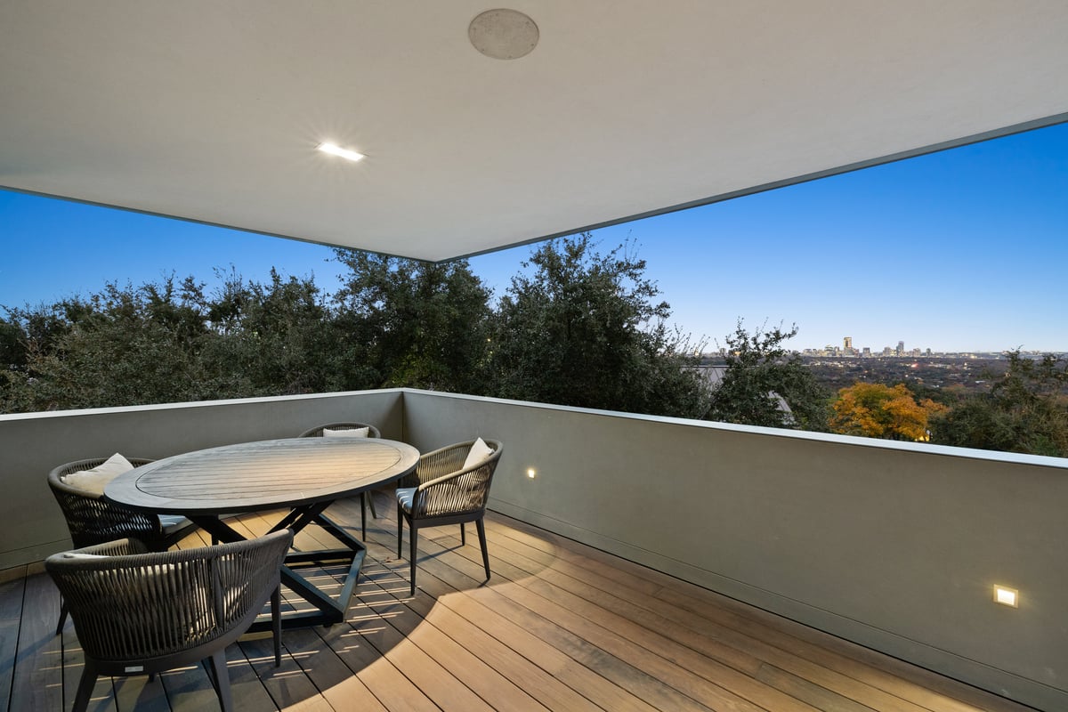 Covered upper terrace with outdoor dining and a view over the hills