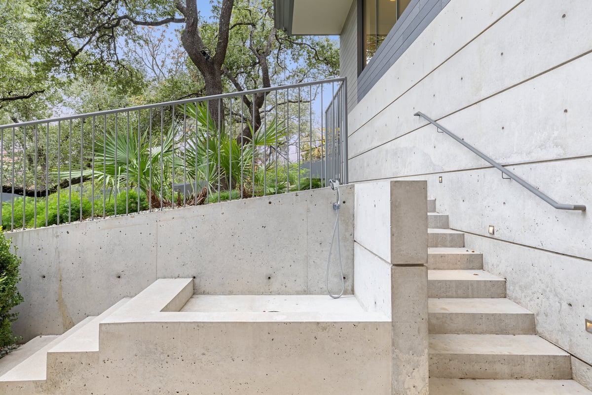 Concrete garden stair descending beside a planted slope