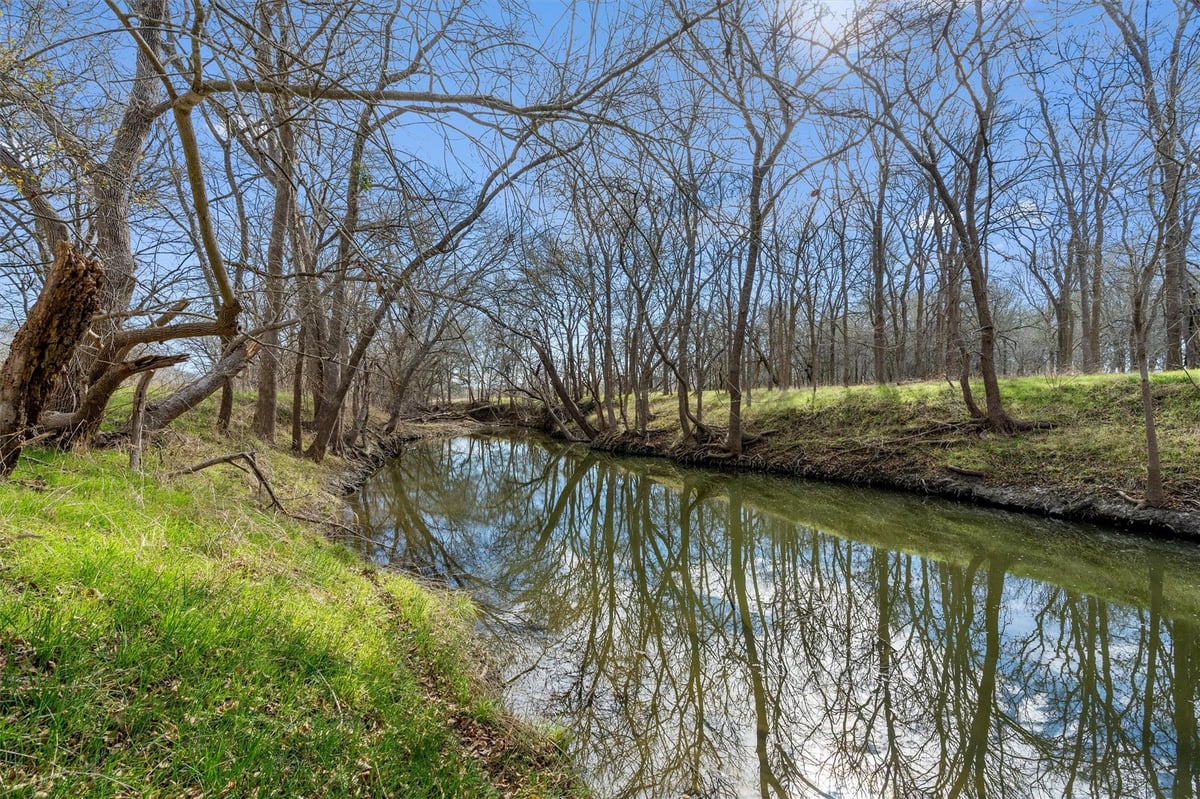 View 0 Rolling Ridge RD in Lockhart 0 Rolling Ridge RD, backyard with creek frontage and mature tree canopy, Lockhart, Lockhart, TX
