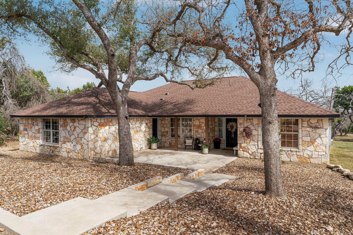 View 1003 Sunset Canyon Dr S in Sunset Canyon Sec II 1003 Sunset Canyon Dr S - front exterior - Luxury home in Sunset Canyon Sec II, Dripping Springs, TX