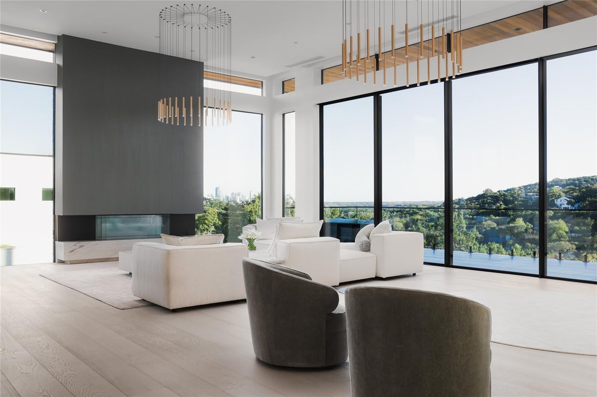 Living area with Floor-to-ceiling black-framed sliding gl at 1003 The High Rd - 7 bed 8 bath home