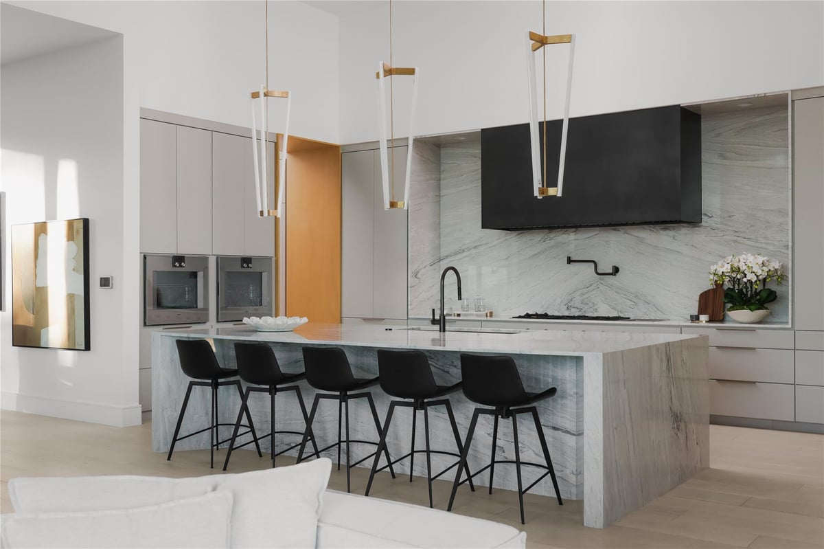 Gourmet kitchen with marble waterfall island countertops at 1003 The High Rd - 7 bed 8 bath home