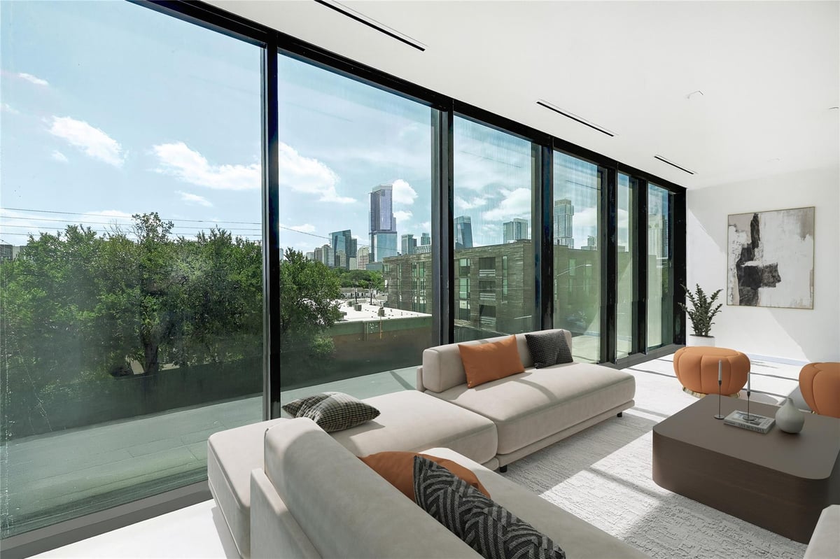 View 1006 Baylor St Unit #203 in Castle East Sub 1006 Baylor St Unit #203 - living area with floor-to-ceiling windows - Luxury home in Castle East Sub, Austin, TX