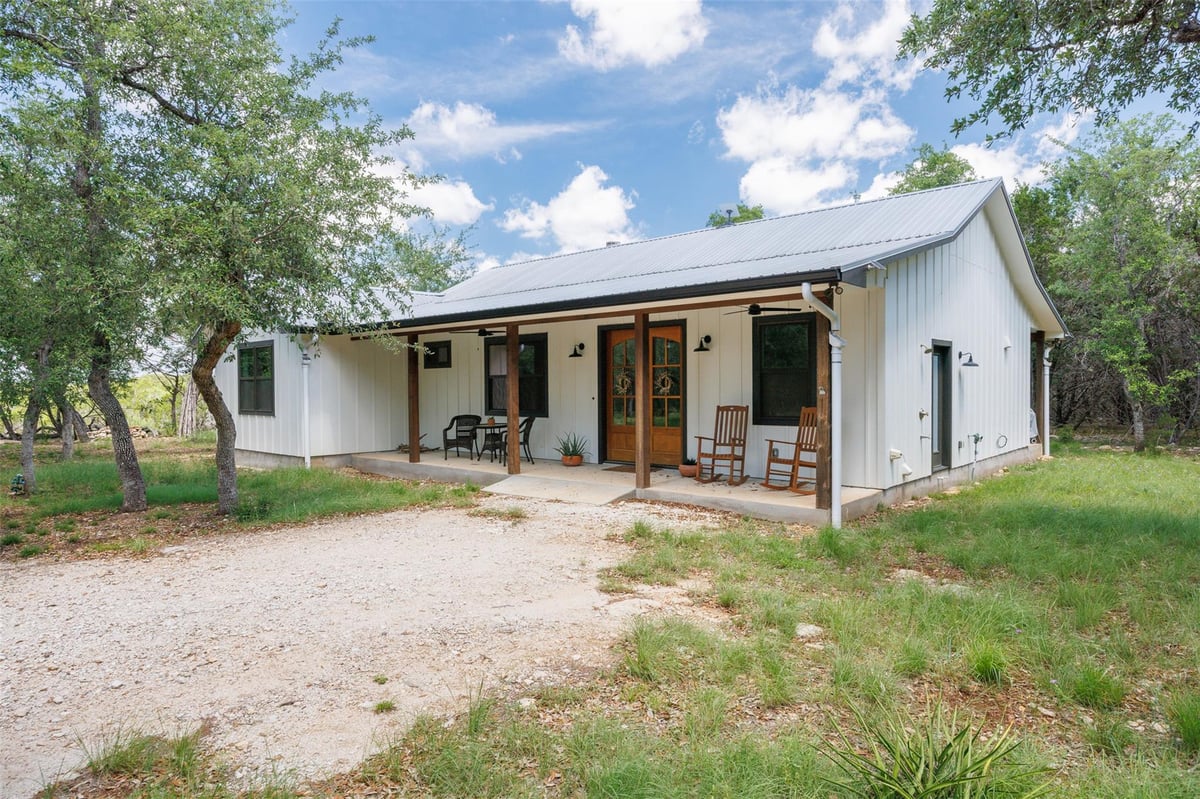View 101 Rambling Oaks DR in River Oaks Of Wimberley Unit 5 101 Rambling Oaks DR - front exterior - Luxury home in River Oaks Of Wimberley Unit 5, Wimberley, TX