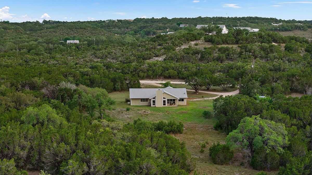 View 102 Rocky Creek RD in Bell Spgs Ranches 102 Rocky Creek RD - front exterior - Luxury home in Bell Spgs Ranches, Dripping Springs, TX