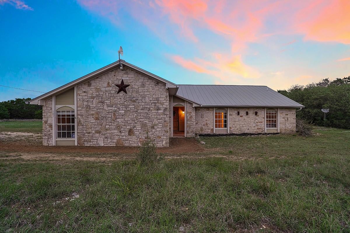 View 102 Rocky Creek Rd in Bell Spgs Ranches 102 Rocky Creek Rd - front exterior - Luxury home in Bell Spgs Ranches, Dripping Springs, TX