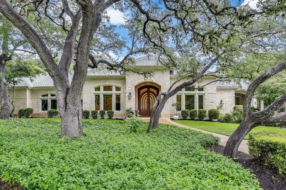 View 102 Wood Trl in Wood Trail Estates 102 Wood Trl - front exterior with West Lake Hills estate setting - Luxury home in Wood Trail Estates, West Lake Hills, TX