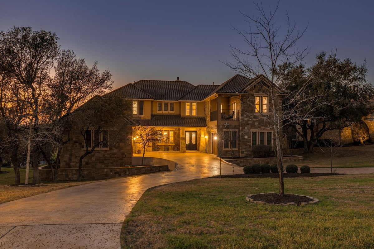 View 104 Bella Strada Cv in Bella Strada 104 Bella Strada Cv - front exterior with twilight traditional facade - Luxury home in Bella Strada, Austin, TX