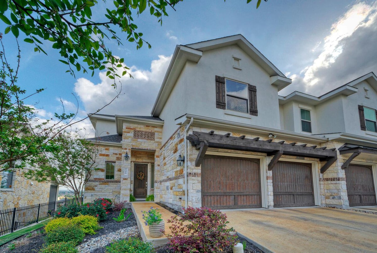 106 Cartwheel Bnd Unit #55 - front exterior - Luxury home in Vineyard at Rough Hollow, Austin, TX