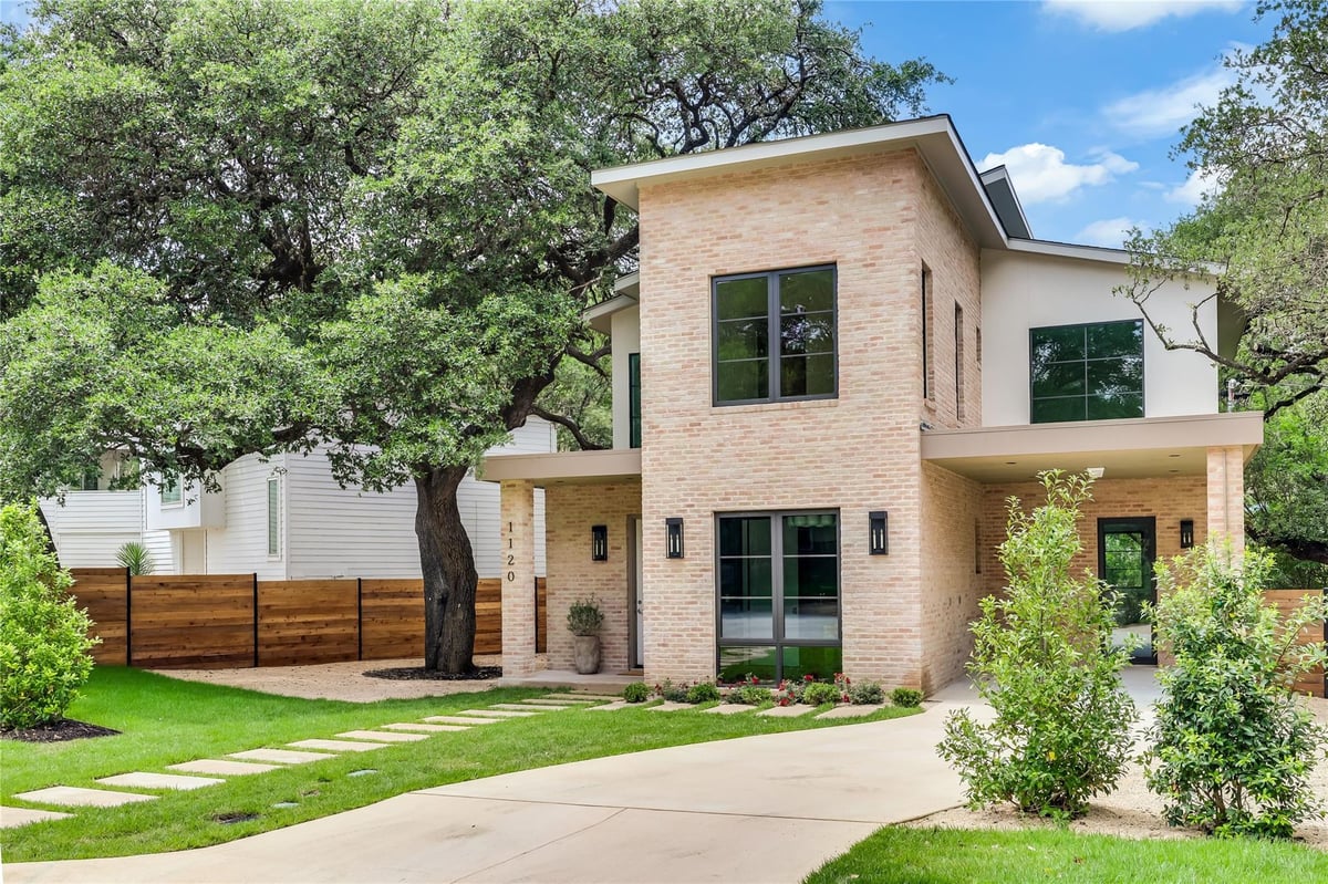 View 1120 Bluebonnet Ln in South Lund Park Sec 05 1120 Bluebonnet Ln - front exterior with modern stucco facade and mature trees - Luxury home in South Lund Park Sec 05, Au...