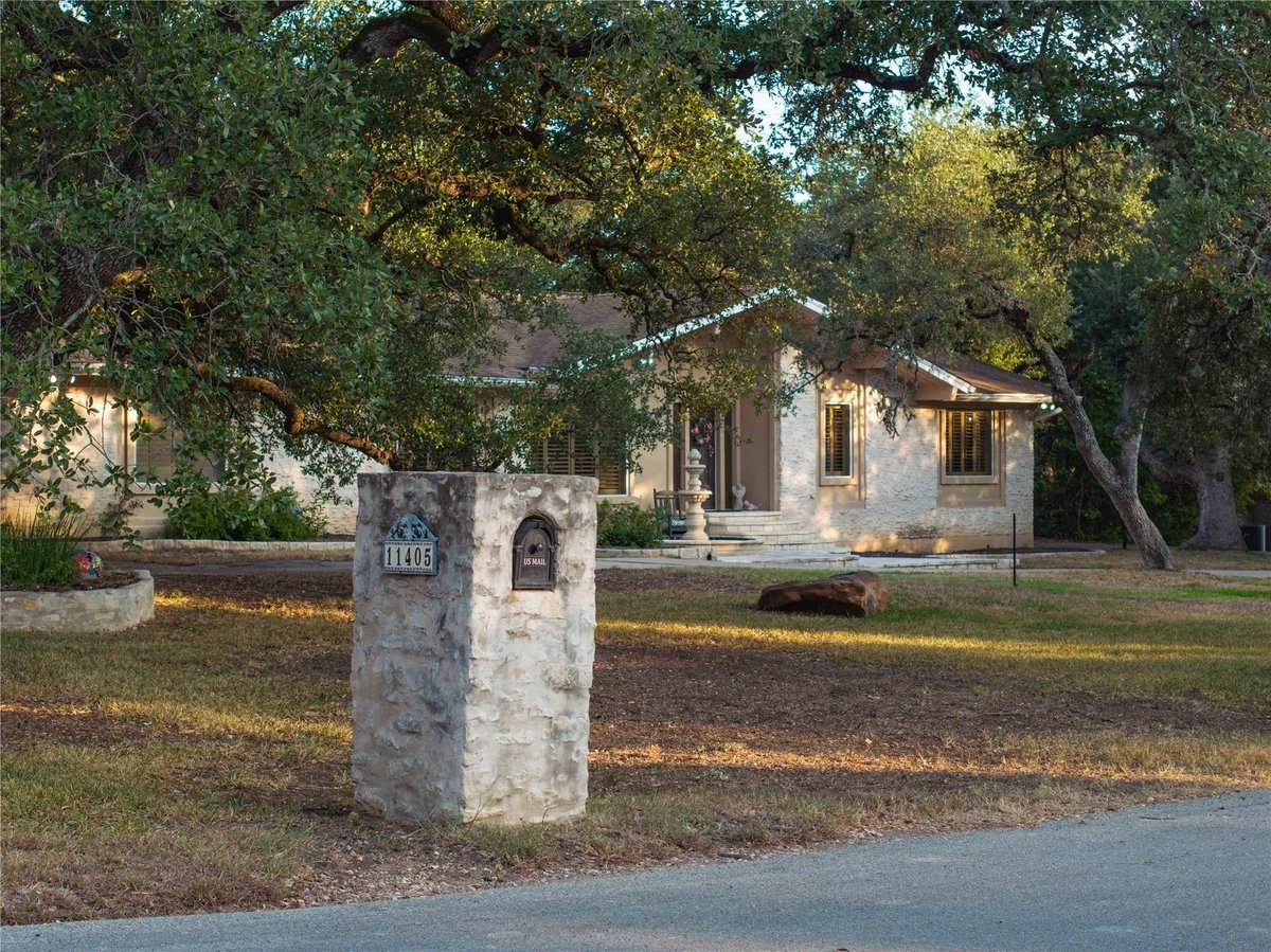 View 11405 Antler Ln in Oak Deer Park 11405 Antler Ln - front exterior with stone entry marker - Luxury home in Oak Deer Park, Austin, TX