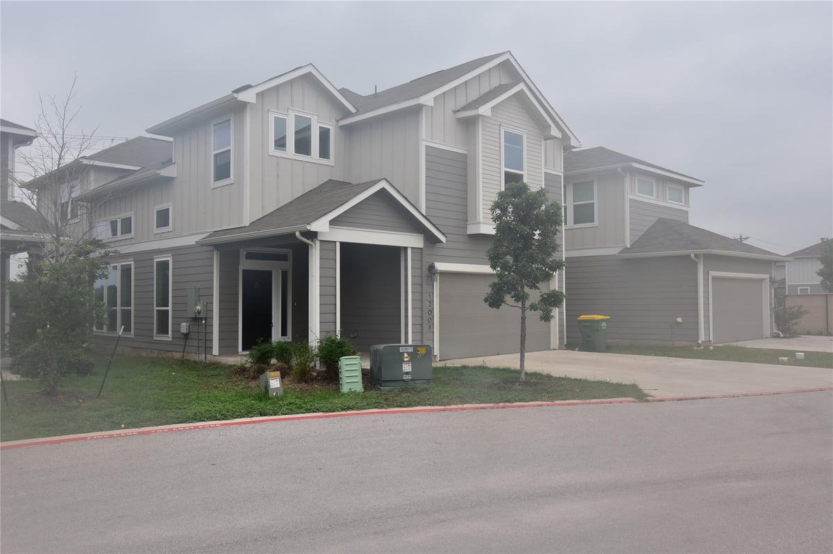 12008 Corsicana Trl Unit #22 - front exterior - Luxury home in ENCLAVE AT LAGOS, Manor, TX