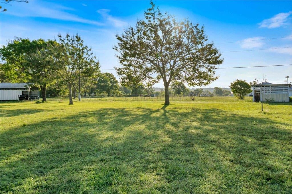 Backyard with expansive acreage and mature oak trees at 1218  Lovers Ln - Austin, Stephen F, Bastrop, TX