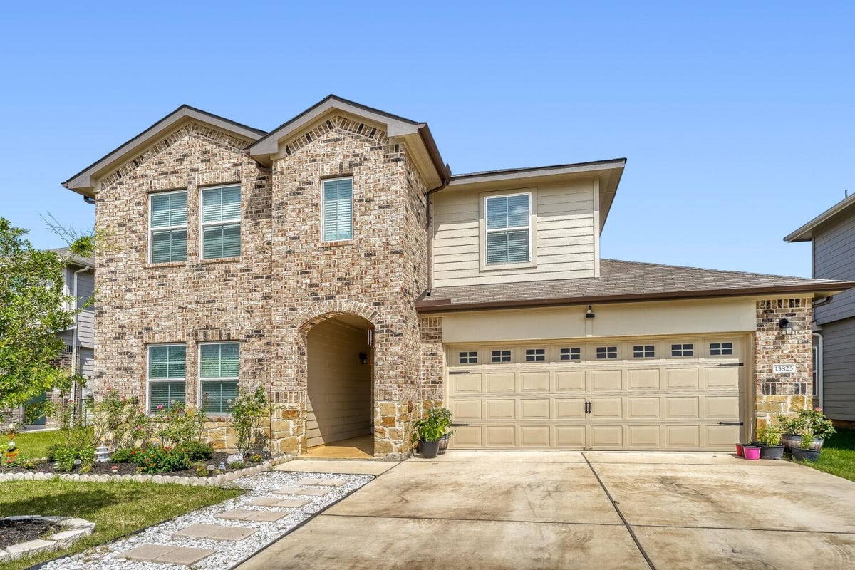 13825 Thomas Wheeler WAY - front exterior - Luxury home in Manor Heights Ph 3 Sec 1, Manor, TX