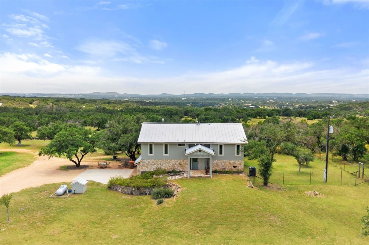 View 143 Oak LN in Pedernales Subdivision of Blanco County 143 Oak LN - front exterior - Luxury home in Pedernales Subdivision of Blanco County, Johnson City, TX