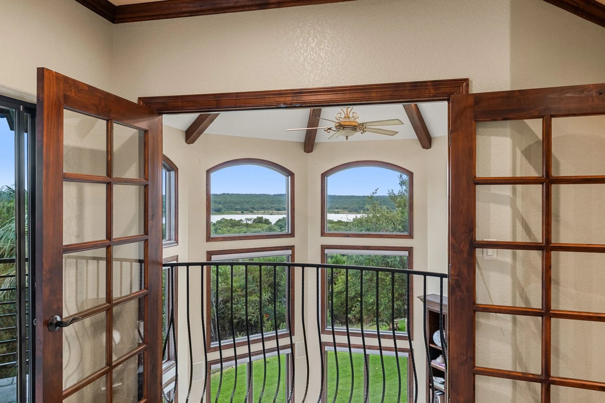 Juliet balcony with French doors framing a Lake Georgetown view