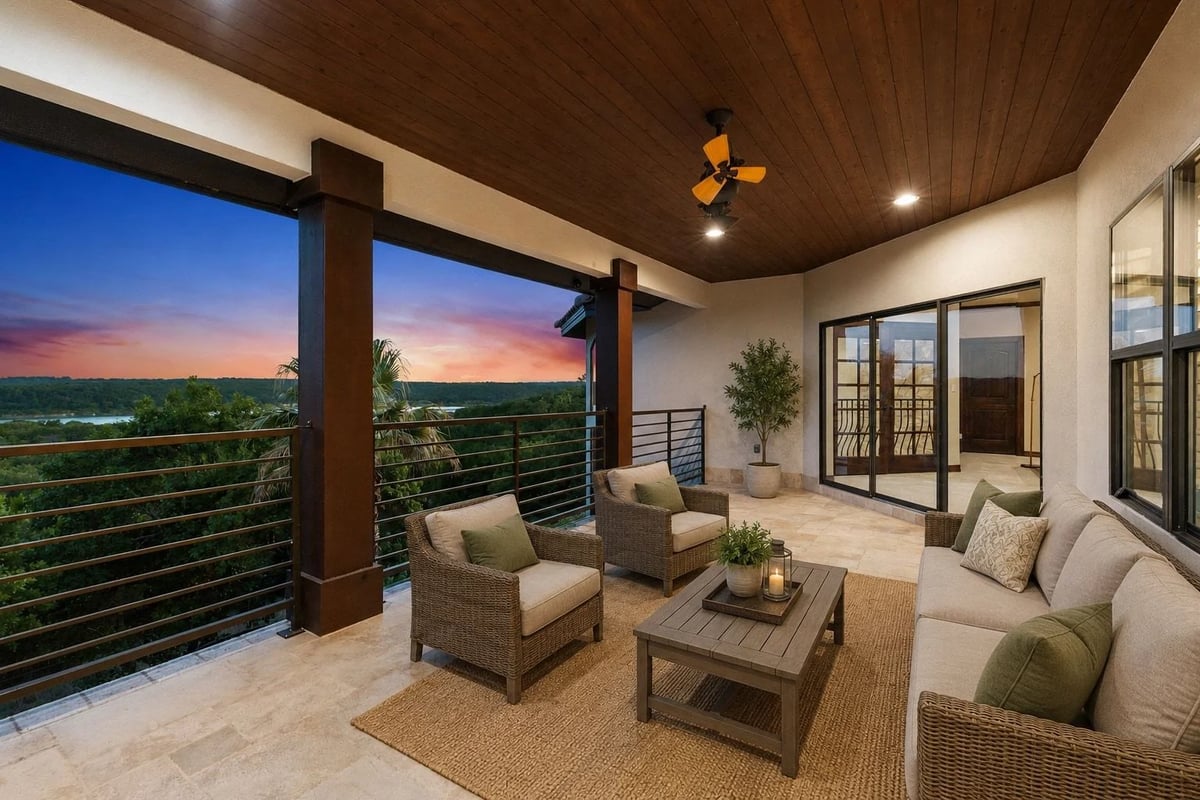Upstairs veranda with wicker seating overlooking Lake Georgetown at sunset