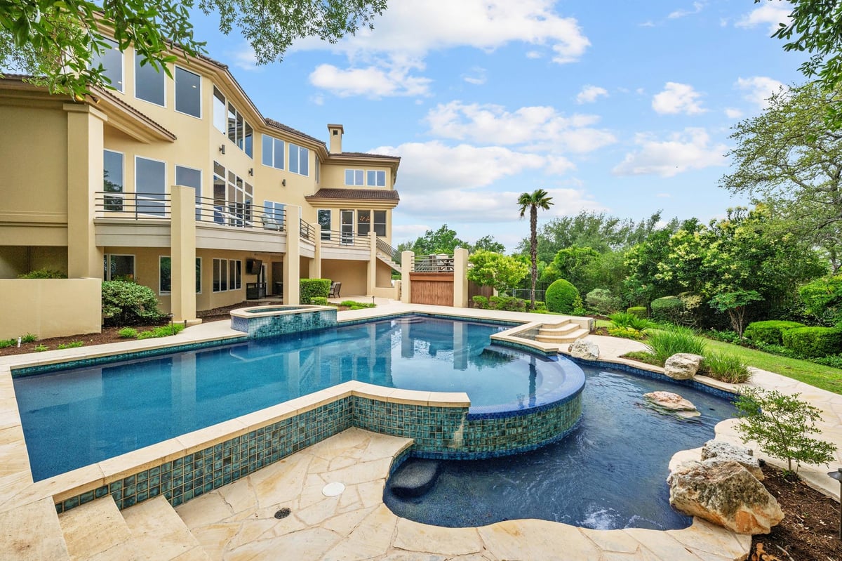 View 15903 Soleil Ct in Vineyard Bay Ph 01 15903 Soleil Ct - pool area with backyard pool and attached spa - Luxury home in Vineyard Bay Ph 01, Austin, TX