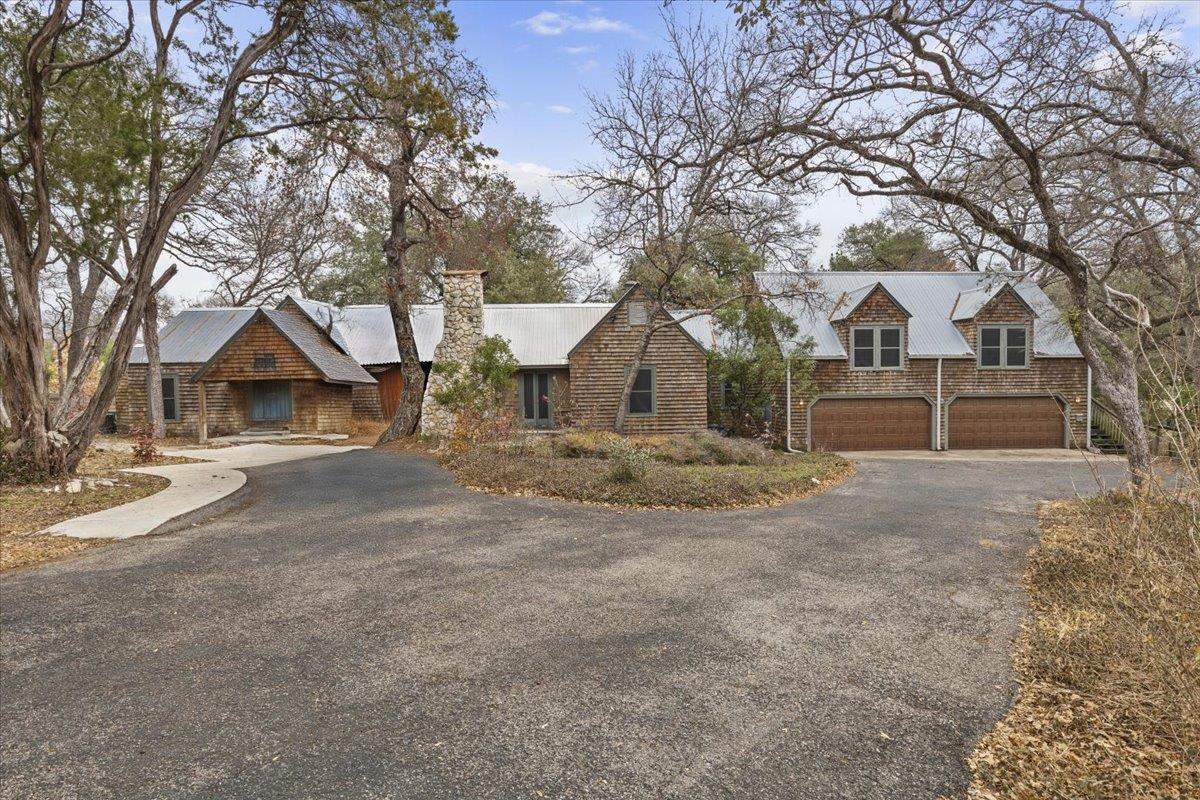 View 1607 Sharon Ln in Westfield A 1607 Sharon Ln - front exterior with large wooded lot and stone facade - Luxury home in Westfield A, Austin, TX