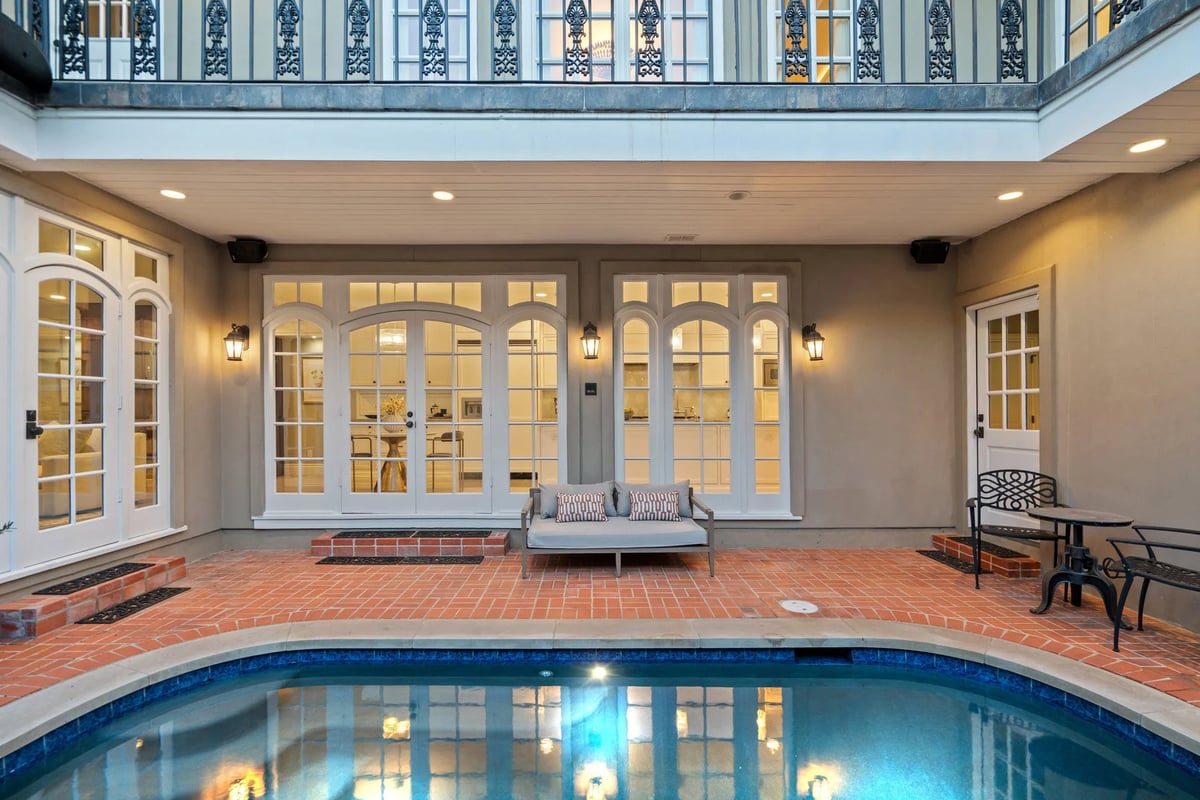 1810 W 35th Street - courtyard pool and brick decking at twilight, view 2
