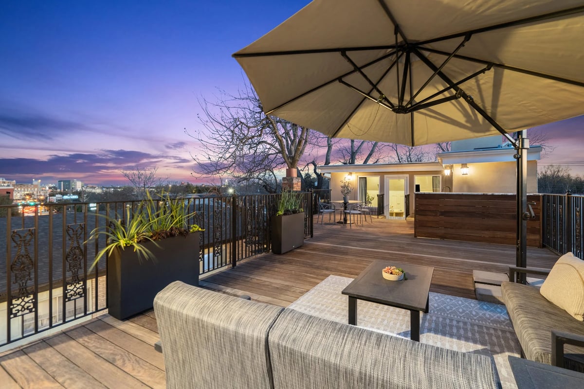 1810 W 35th Street - Ipe roof deck with outdoor kitchen at twilight, view 3
