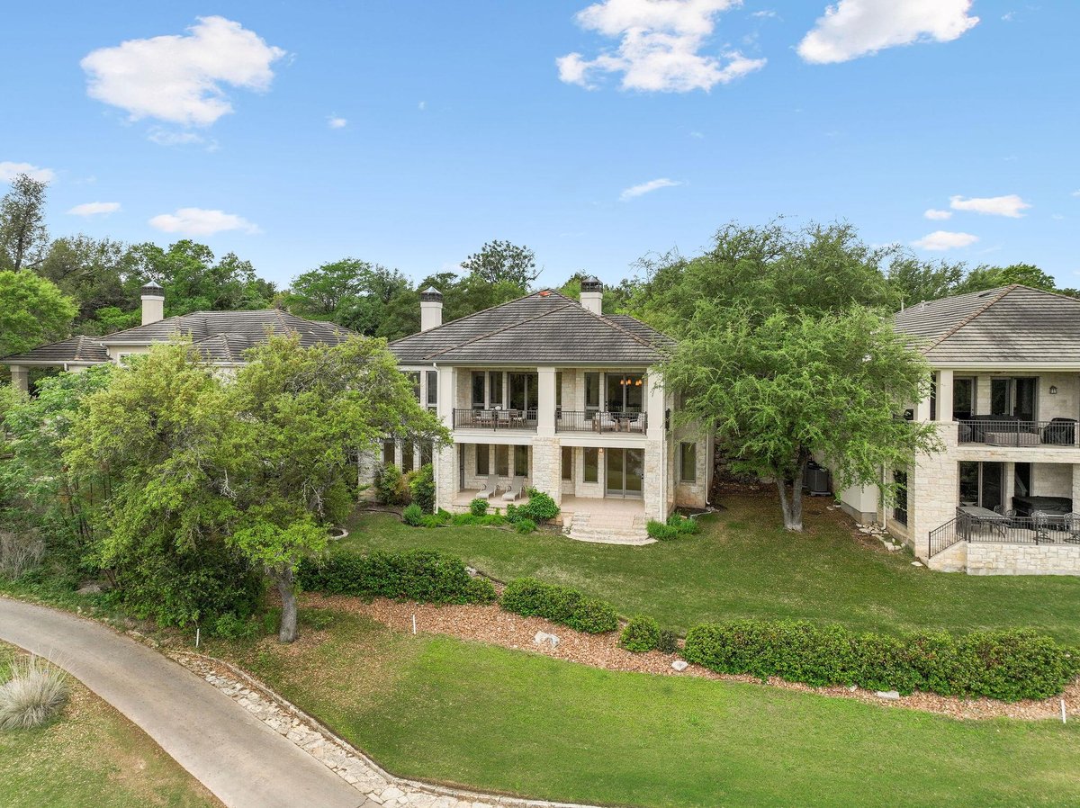 View 2305 Barton Creek BLVD Unit #25 in Fairways On Fazio At Barton Creek Co 2305 Barton Creek BLVD Unit #25 - living area with bright living room and stone fireplace - Luxury home in Fairways On Faz...
