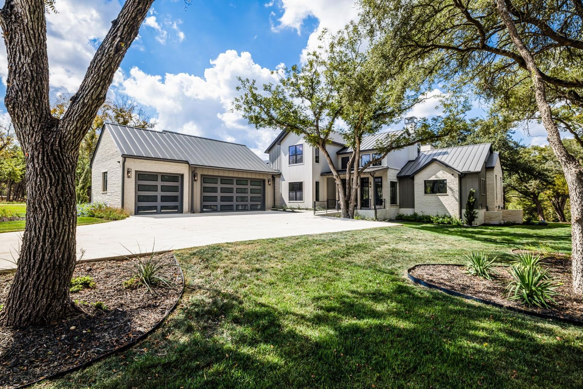 View 232 Riverfront Dr in Bluffs On The Guadalupe 232 Riverfront Dr - front exterior with 232 Riverfront Dr in New Braunfels - Luxury home in Bluffs On The Guadalupe, New...