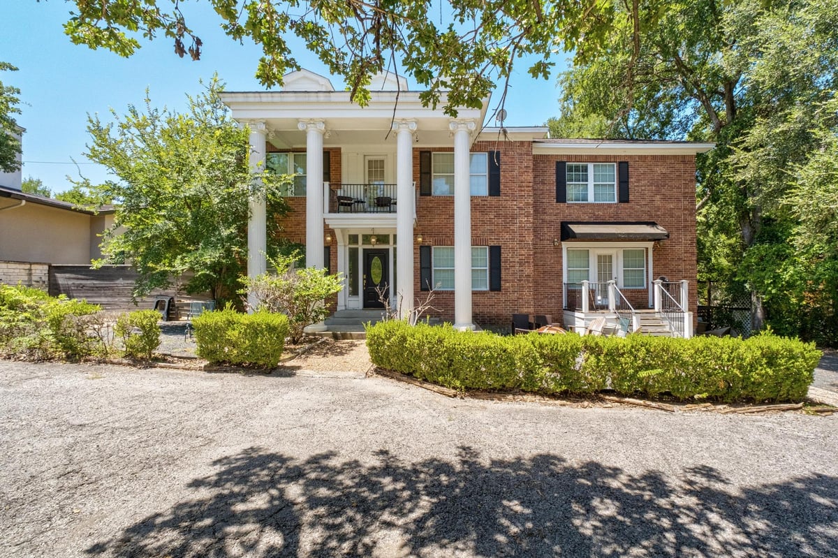View 2413 Enfield RD in Westfield A 2413 Enfield RD - front exterior with classic brick facade and columned entry - Luxury home in Westfield A, Austin, TX