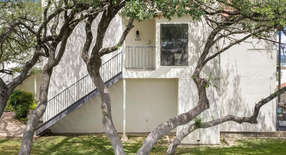 View 2918 Ranch Road 620 Unit #C122 in Villas On Travis Condo Amd 2918 Ranch Road 620 Unit #C122 - front exterior - Luxury home in Villas On Travis Condo Amd, Austin, TX
