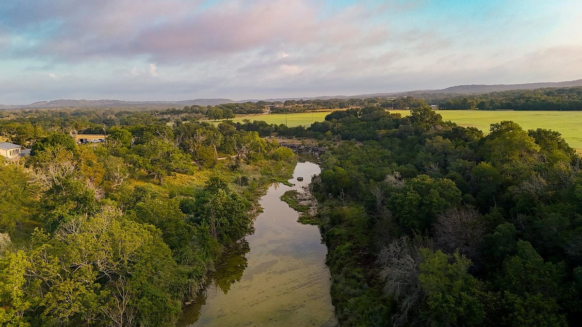 Aerial view with Hill Country river views at 3067 Ranch Road 1888 - Blanco, TX