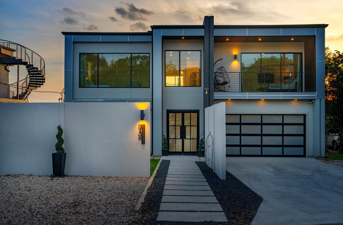 View 3138 Chisholm TRL in Apache Shores 01 Instl 3138 Chisholm TRL - front exterior with modern facade and twilight entry - Luxury home in Apache Shores 01 Instl, Austin, TX