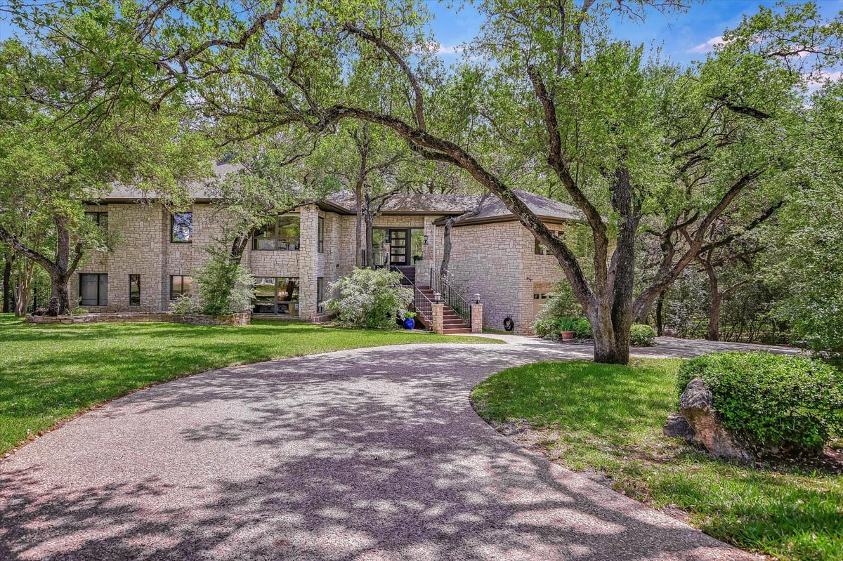 View 3901 Prentice Ln in West Rim 3901 Prentice Ln - front exterior with circular drive and mature oak trees - Luxury home in West Rim, Austin, TX