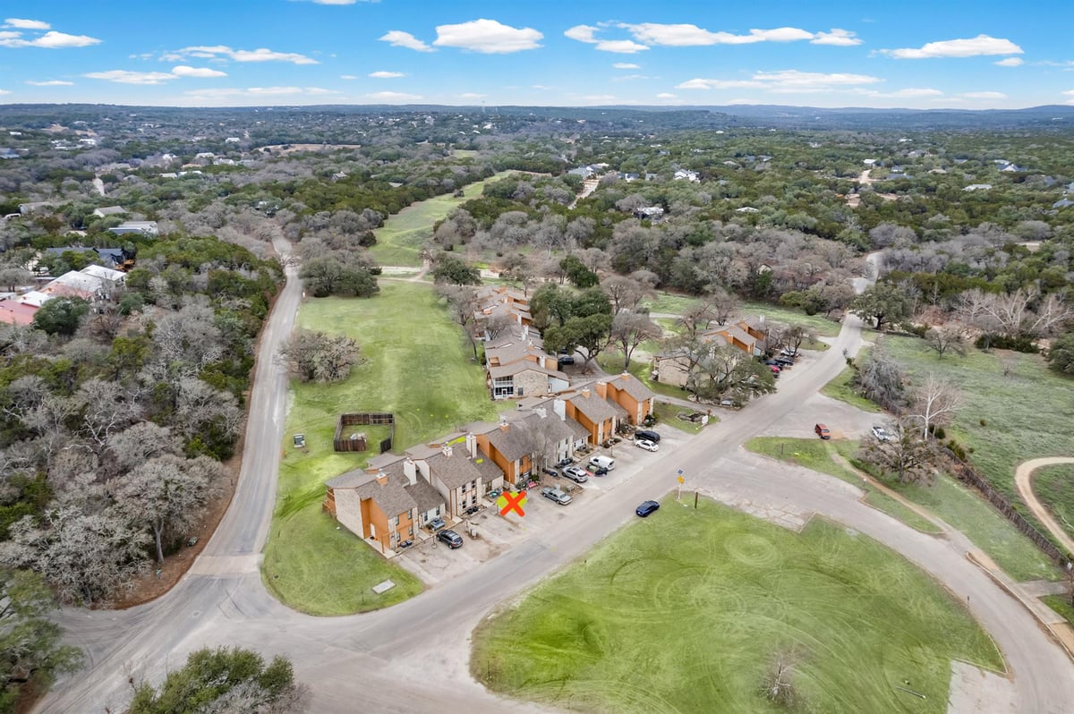 View 4 Cypress Fairway Vlg in Cypress Fairway Village 1 4 Cypress Fairway Vlg - front exterior - Luxury home in Cypress Fairway Village 1, Wimberley, TX