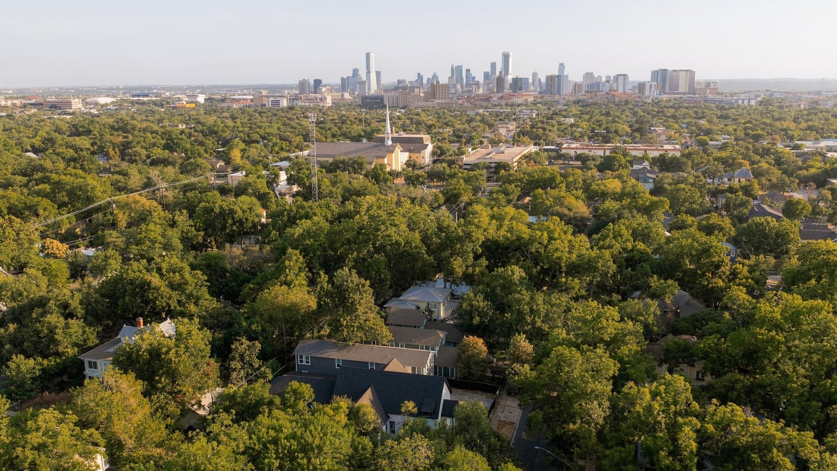 Aerial view over the Hyde Park tree canopy to the downtown Austin skyline