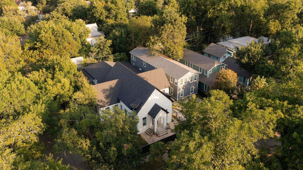 Aerial view of the church and the fourplex among the Hyde Park trees