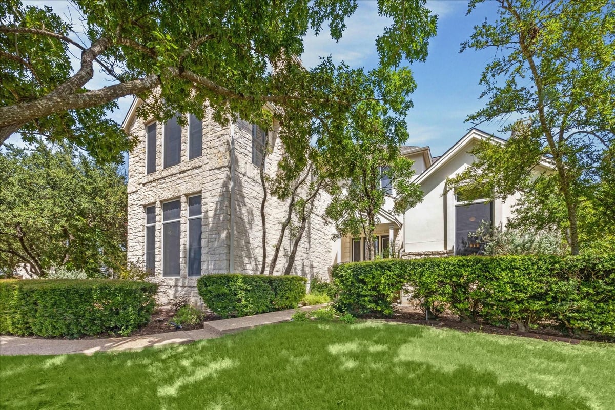 View 4307 Waterford Pl in Waterford Place Sec 02 Amd 4307 Waterford Pl - front exterior with white brick facade - Luxury home in Waterford Place Sec 02 Amd, Austin, TX