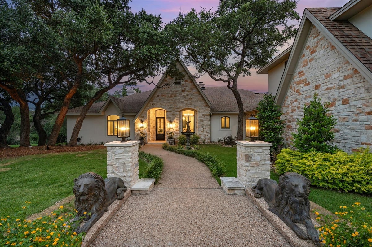 View 4710 Eck Lane in Bayview Acres 4710 Eck Lane - front exterior with stone facade and arched entry - Luxury home in Bayview Acres, Austin, TX