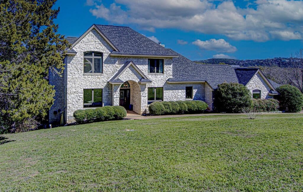 View 4800 Mantle DR in Bull Mountain Ph 04 Sec 01 4800 Mantle DR - front exterior with stone facade and twilight curb appeal - Luxury home in Bull Mountain Ph 04 Sec 01, Au...