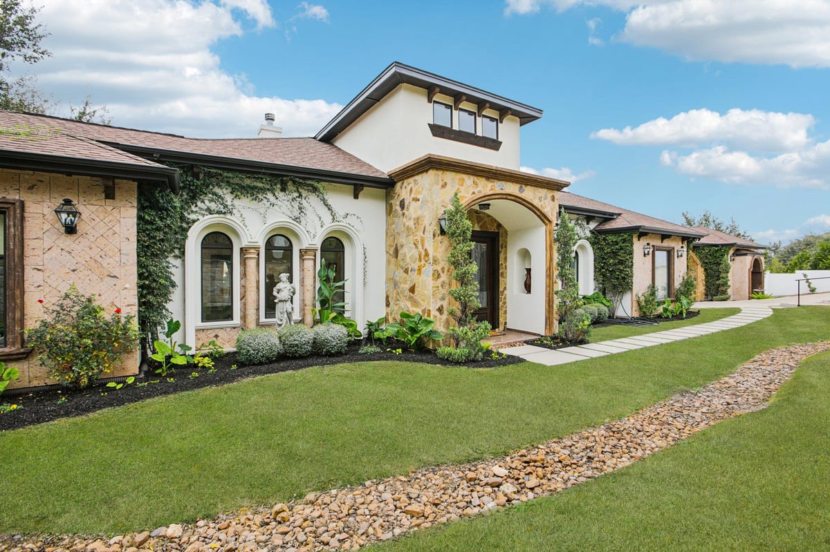 View 5005 McIntyre Cir in Travis Landing 02 Ph 03 5005 McIntyre Cir - front exterior with stone and stucco facade and arched entry - Luxury home in Travis Landing 02 Ph 03,...