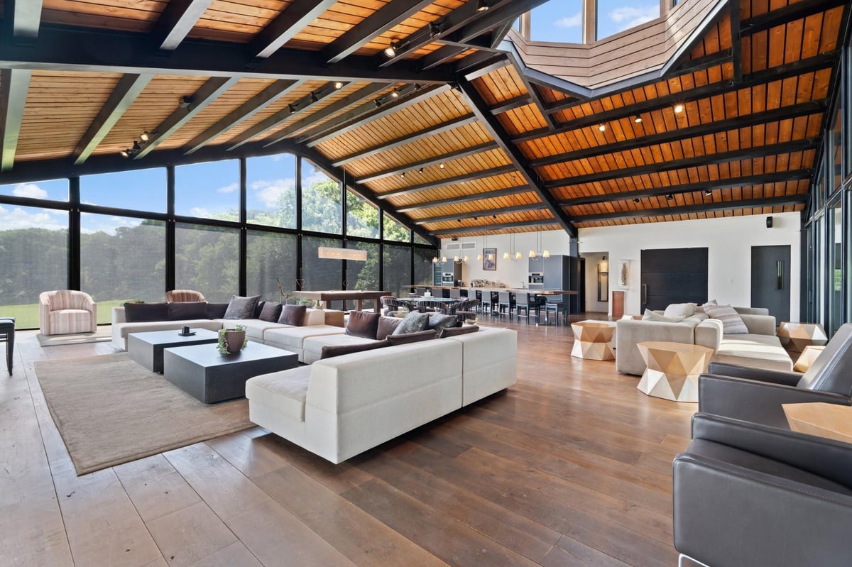 Living area with Floor-to-ceiling black-framed glass wall at 5055 Wayside Dr - None, Wimberley, TX