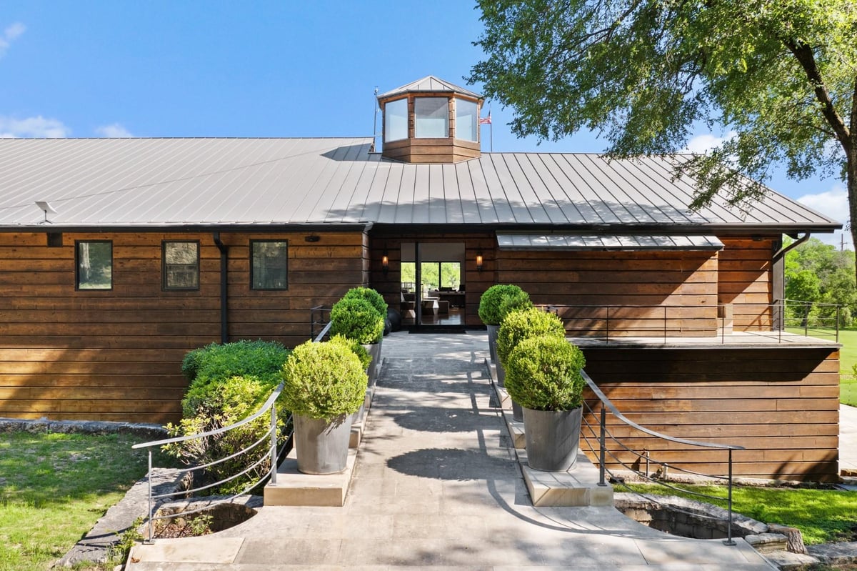 Front exterior with Modern farmhouse architecture at 5055 Wayside Dr - None, Wimberley, TX